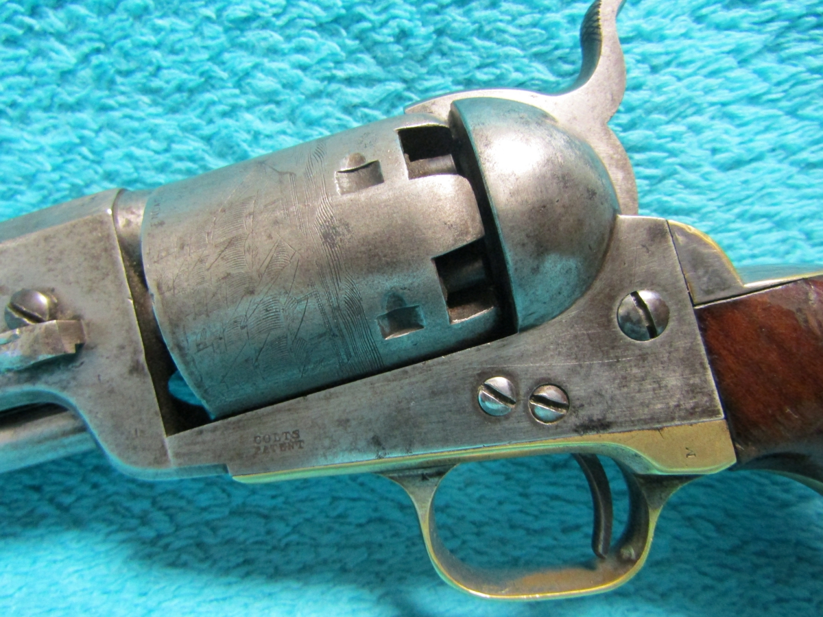 Colt Mod. 1851 Navy,engraved,silver plating,cased,postwar,cal..36,no.  16337. Matching numbers. Octagonal barrel,bright bore,length 7-1/2. Six  shots. Manufactured in 1975. Firm address on barrel,on frame marked Colts  Patent. On cylinder roll